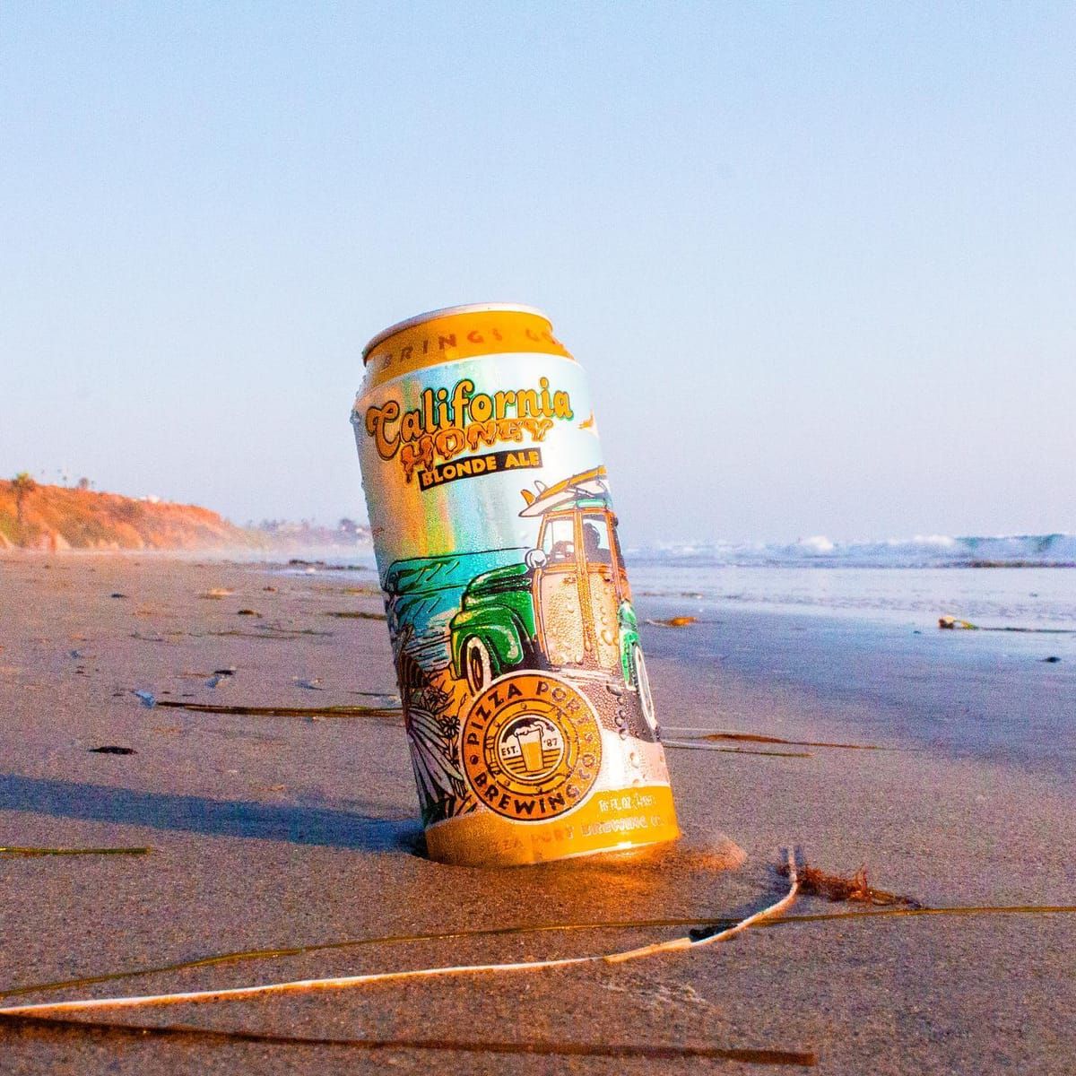 California Honey can standing on the sand at sunset