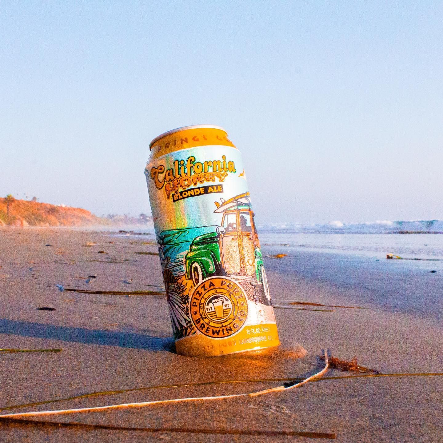 California Honey can standing on the sand at sunset