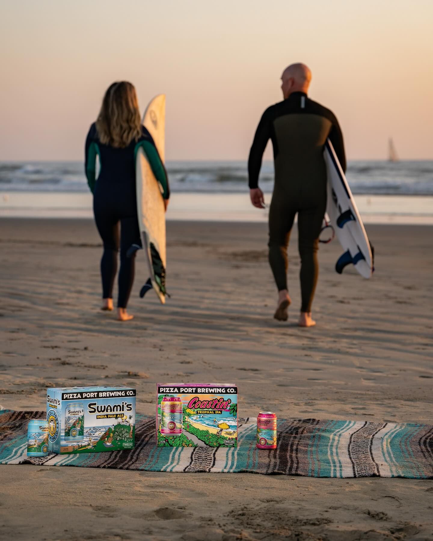 Surfers on the beach with Pizza Port Swami's and Coastin' beer